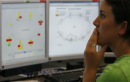 A Scientist looks at computer screens at the LHC control center of the CERN in Geneva. REUTERS/Christian Hartmann.