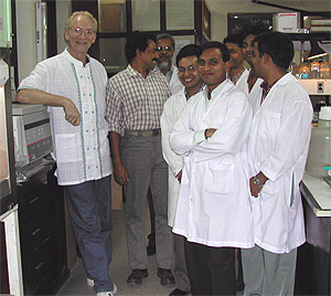John Mekalanos next to Dr. Shah Faruque, his collaborator on cholera studies at the International Center for Diarrhea Disease Research, Dhaka, Bangladesh and other members of his research group.