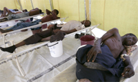 Cholera patients rest on their beds inside the male ward of Budiriro Polyclinic in Harare December 1, 2008.REUTERS/Philimon Bulawayo.