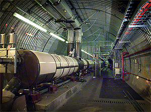Brookhaven National Laboratory's Relativistic Heavy Ion Collider (RHIC) is really two accelerators in one — made of crisscrossing rings of superconducting magnets, enclosed in a tunnel 2.4 miles in circumference. In the two rings, beams of heavy ions are accelerated to nearly the speed of light in opposite directions, held in their orbits by powerful magnetic fields. Shown here is an area near the BRAHMS experiment.