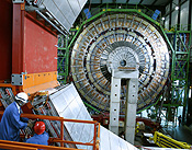 Two technicians assemble an element of the CMS experiment at the CERN in the village of Cessy. REUTERS/Denis Balibouse.