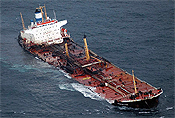 The stricken Bahamas registered tanker Prestige, loaded with 77,000 tonnes of fuel oil, drifts powerless off northwestern Spain November 14, 2002. The tanker spilled tonnes of fuel oil into the sea leaving a slick over 200 metres wide and 30 kilometres long as rescue services battled to tow it further out to sea. Twenty-four crew members were airlifted to safety yesterday. REUTERS/Miguel Vidal.