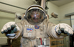A Russian Cosmonaut Sergey Volkov tries on a space suit during a training exercise at the Star City training centre outside Moscow March 30, 2011. REUTERS/Sergei Remezov.