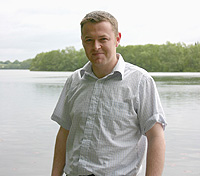 Conor Graham next to Schöhsee, a lake in Northern Germany. The Max Planck Institute of Limnology, Plön, is located on its shores. Photo credit Dr. Chris Harrod, QUB