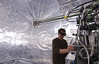 Scientist tuning the instrumentation before an experiment at the "smog" chamber at the Paul Scherrer Institut in Switzerland. Photo credit: Urs Baltensperger.