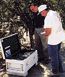 Elias Fereres (left) and Mario Salinas inspect dataloggers and associated equipment that were used to record daily trunk growth.