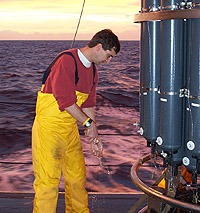 Click to enlarge. Scott Doney collecting a water sample on the NOAA R/V Ronald H. Brown in the South Atlantic as part of a global survey of ocean carbon distributions.