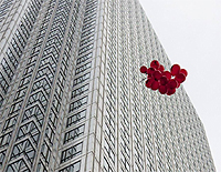 Red balloons are released outside the Financial Services Authority offices in London's Canary Wharf financial district September 15, 2009. REUTERS/Kevin Coomb.